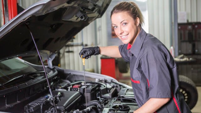 A Mechanic woman working on car in his shop